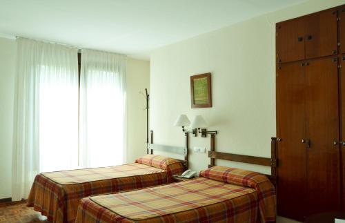 Postel nebo postele na pokoji v ubytování Hotel Termas de Liérganes