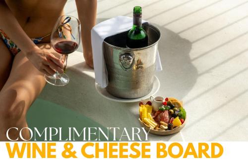 a woman with a glass of wine and cheese board at Proud Phu Fah Muang Chiang Mai in Chiang Mai