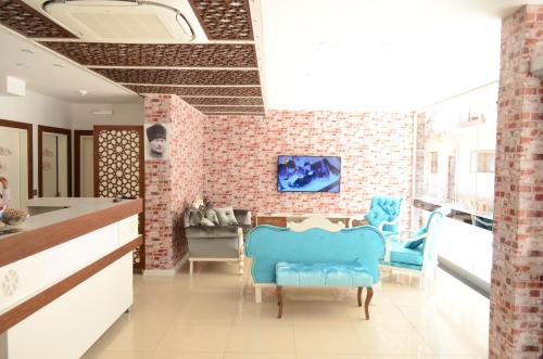 a kitchen with a brick wall and blue chairs at Sinop Dolunay Hotel in Sinop