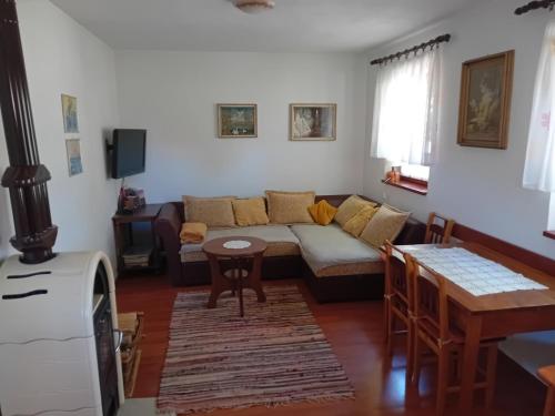 a living room with a couch and a table at Bakina kućica - Grandma's cottage in Gospić