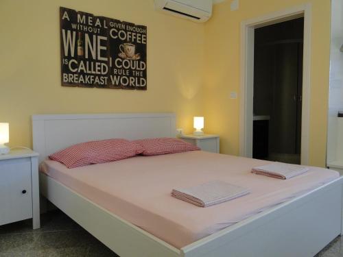 a bed with two pillows on it in a bedroom at Villa Ester in Umag