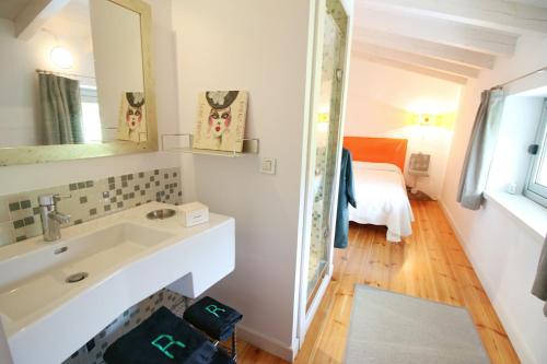 a bathroom with a sink and a mirror and a bed at Villas San Roque Isla in Isla