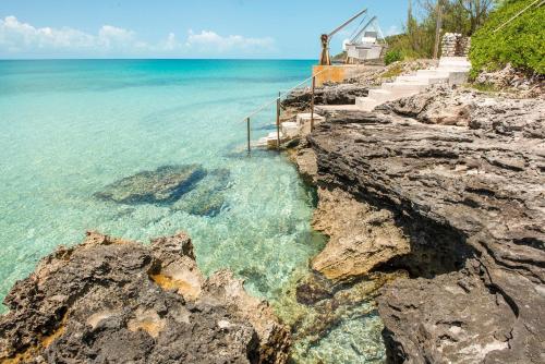 a view of the ocean from a cliff at Touch of Class Villa - A Caribbean Beachfront Home villa in Savannah Sound