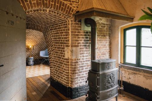 a brick wall with a stove in a room at Fort Vuren in Vuren
