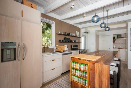 a kitchen with a wooden island in a room at Touch of Class Cottage - A Caribbean Beachfront Cottage cottage in Savannah Sound