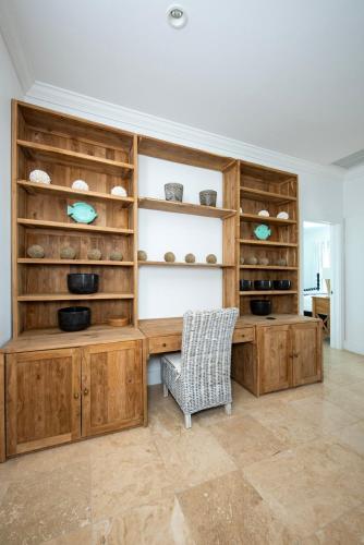 a home office with wooden cabinets and a chair at Turtle Pointe - Lux New Windermere Home withPool, Boat Dock, Beach home in Savannah Sound