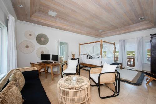 a living room with a bed and a couch and chairs at Turtle Pointe - Lux New Windermere Home withPool, Boat Dock, Beach home in Savannah Sound