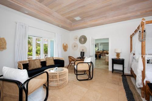 a living room with a couch and a table at Turtle Pointe - Lux New Windermere Home withPool, Boat Dock, Beach home in Savannah Sound