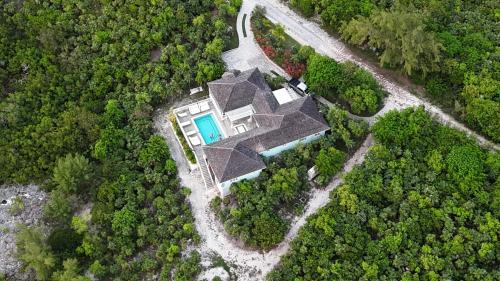 an aerial view of a house in the forest at Turtle Pointe - Lux New Windermere Home withPool, Boat Dock, Beach home in Savannah Sound