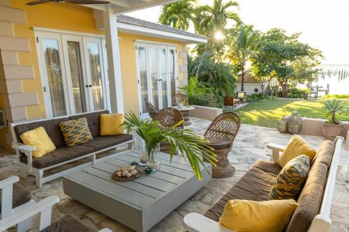 a patio with a couch and a table at Beehive Harbour Island, Luxury Dream World on the Bay, Private d home in Harbour Island