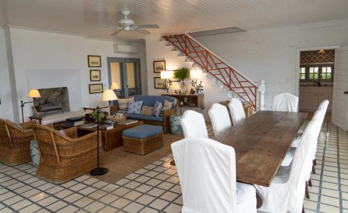 a dining room and living room with a table and chairs at Beehive Harbour Island, Luxury Dream World on the Bay, Private d home in Harbour Island