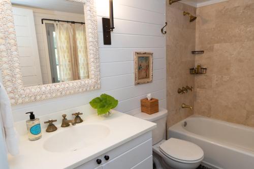 a bathroom with a sink and a toilet and a tub at Beehive Harbour Island, Luxury Dream World on the Bay, Private d home in Harbour Island
