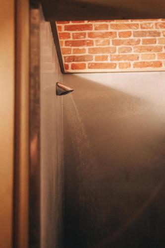 a pipe sticking out of the side of a brick wall at Fort Vuren in Vuren
