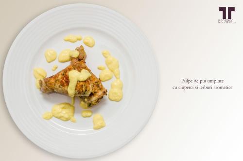 a white plate with a piece of food on it at Hotel Tolea in Târgovişte