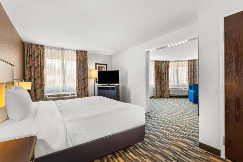 a hotel room with a bed and a television at Quality Inn & Suites Denver International Airport in Denver