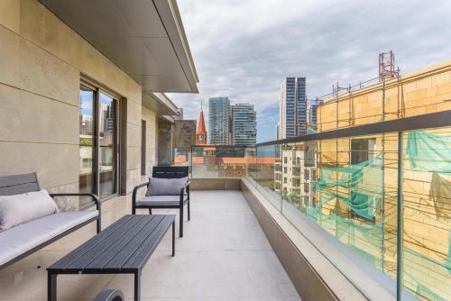 a balcony with benches and a view of the city at Solidere Lavish Apartments in Downtown Beirut in Beirut