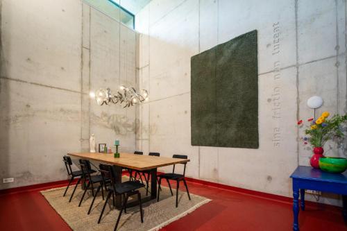 a dining room with a wooden table and black chairs at Fort Vuren in Vuren