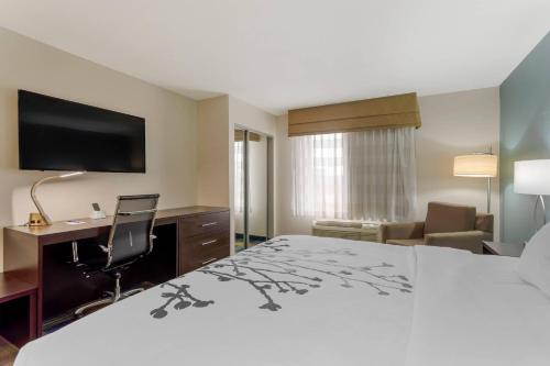 a hotel room with a bed and a desk and a computer at Sleep Inn & Suites Smyrna - Nashville Area in Smyrna