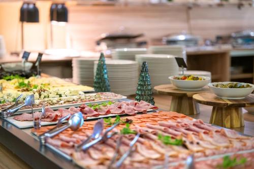 a buffet line with many different types of food at Terme Banovci - Mobilne hiške Med Brajdami in Banovci