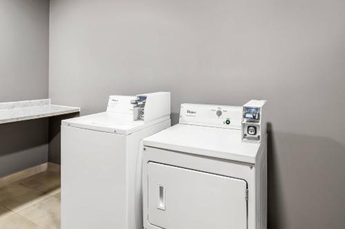a white laundry room with a washer and dryer at Comfort Inn Emporia in Emporia