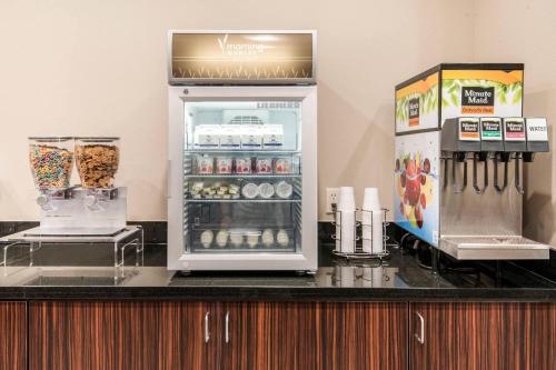 a refrigerator on top of a counter with food at MainStay Suites Moab near Arches National Park in Moab