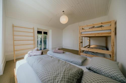 a room with three bunk beds and a window at Stylish Jura house for 10 guests in Grandval