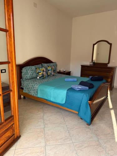 a bedroom with a bed with a mirror and a dresser at Casa Roma in Domusnovas