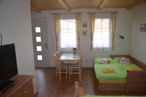 a small bedroom with a bed and a table at Ubytování u Muzea hraček in Lednice