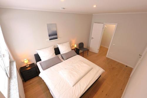 a bedroom with a large white bed in a room at Ausblick residence in Badenweiler