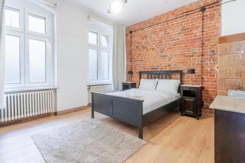 Gliwice Industrial Brick Style Apartment by BookingHost