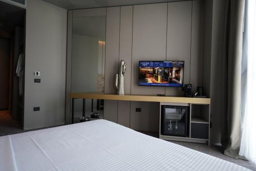 a bedroom with a bed and a television on a desk at The Central View Boutique Hotel in Vlorë