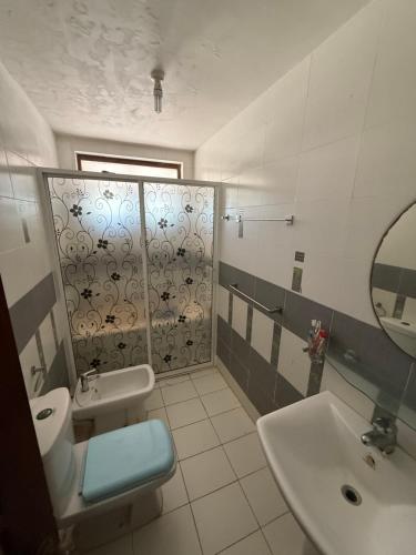 a bathroom with a sink and a toilet and a mirror at Blue Maalu Resort in Ambalangoda