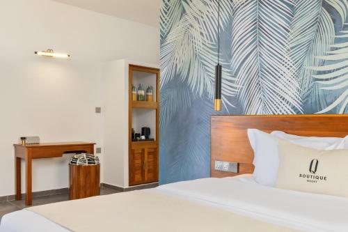 a hotel room with a bed and a desk at Q Boutique Resort Malindi in Malindi