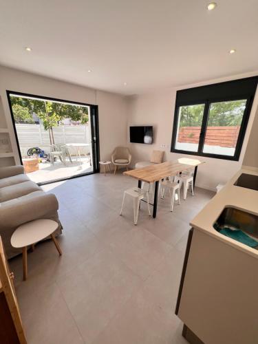 a living room with a table and chairs and a couch at Camping Joncar Mar in Roses