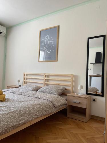 a bedroom with a bed and a mirror at 4 Roses Residence in Sečovlje