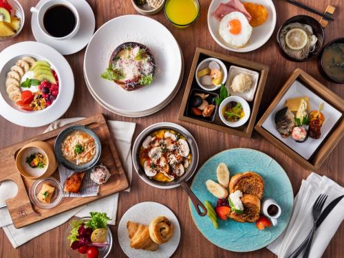 a table with many plates of food on it at Mitsui Garden Hotel Ginza Tsukiji in Tokyo