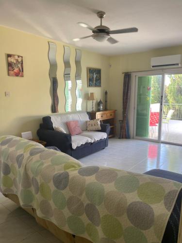 a living room with a bed and a couch at Pelagos Hill Apartment in Paphos