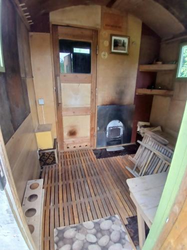 an interior view of a tiny house with a fireplace at Oravapesa B & B & saun in Kose