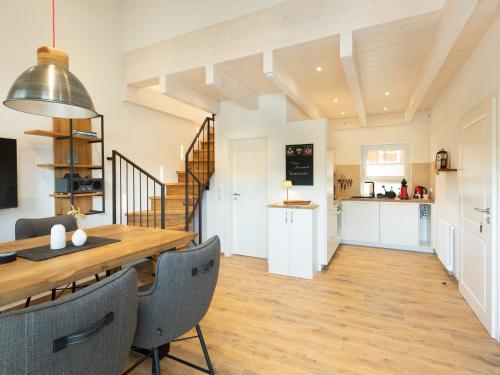 a kitchen and dining room with a wooden table and chairs at Ferienwohnung Verschnuufeckli in Wehr