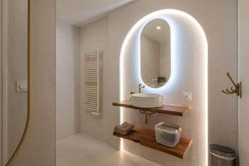 a bathroom with a sink and a mirror at La roche étoilée - Jacuzzi in Vienne