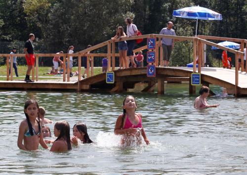 a group of girls swimming in the water at Apartmaji Koželj in Ribnica na Pohorju