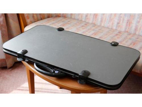 a laptop computer sitting on top of a table at Ako Park Hotel in Ako