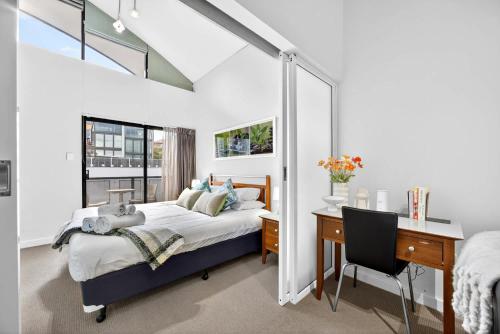 a bedroom with a bed and a desk and a deskablish at Cloud Nine City Centre 1BDR in Perth