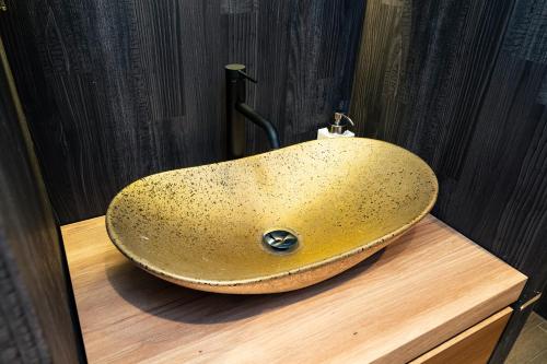 a sink on a wooden counter in a bathroom at Koala Inn Ueno in Tokyo