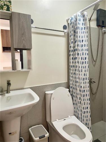 a bathroom with a sink and a toilet and a shower at Peaceful Studio at The Median - City Skyline View, Short Walk to IT Park in Cebu City