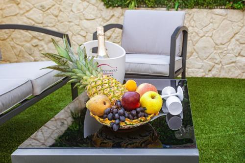 a bowl of fruit on a table on a patio at Holiday Apartment Piazza Bacio Sublime in Fiumefreddo di Sicilia