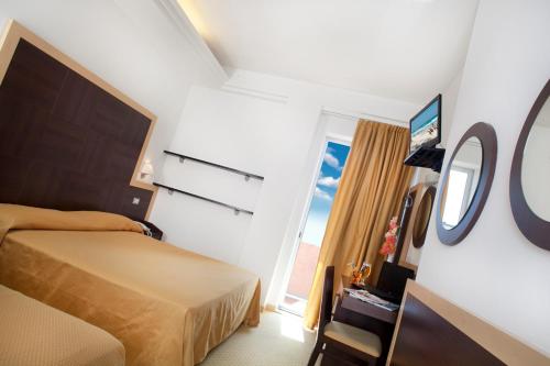 Cama ou camas em um quarto em Hotel San Salvador