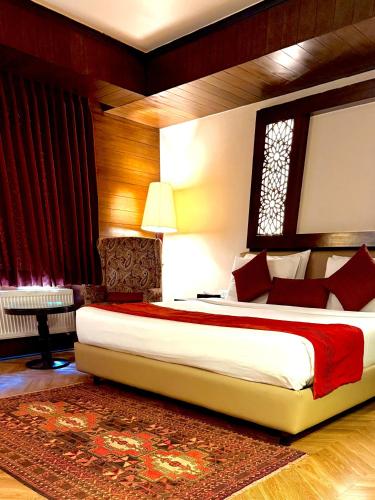 a bedroom with a large bed and a window at The Vintage Gulmarg in Gulmarg