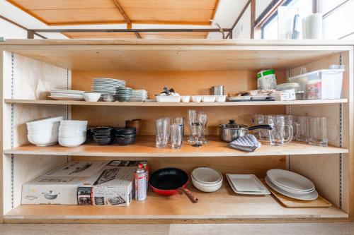 a cabinet filled with dishes and other kitchen items at King Deer in Higashikawa