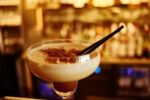 a drink in a glass with a stick in it at Welcome Hotel in Villefranche-sur-Mer